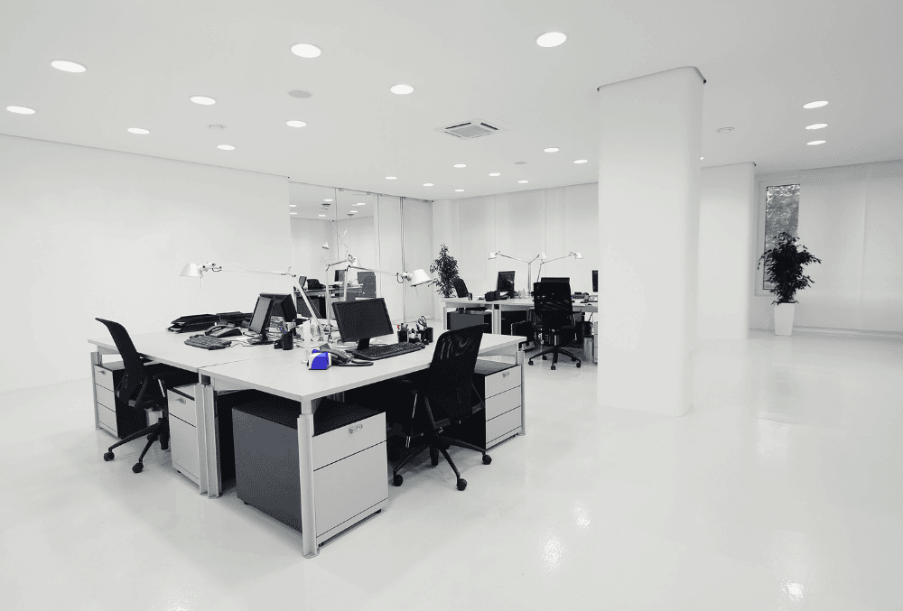 ell-organized office space with a table, chairs, and computers
