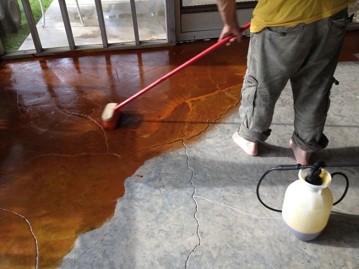 man staining concrete floors