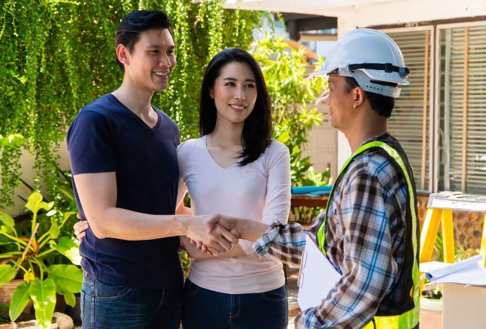 couple talking to a concrete flooring contractor
