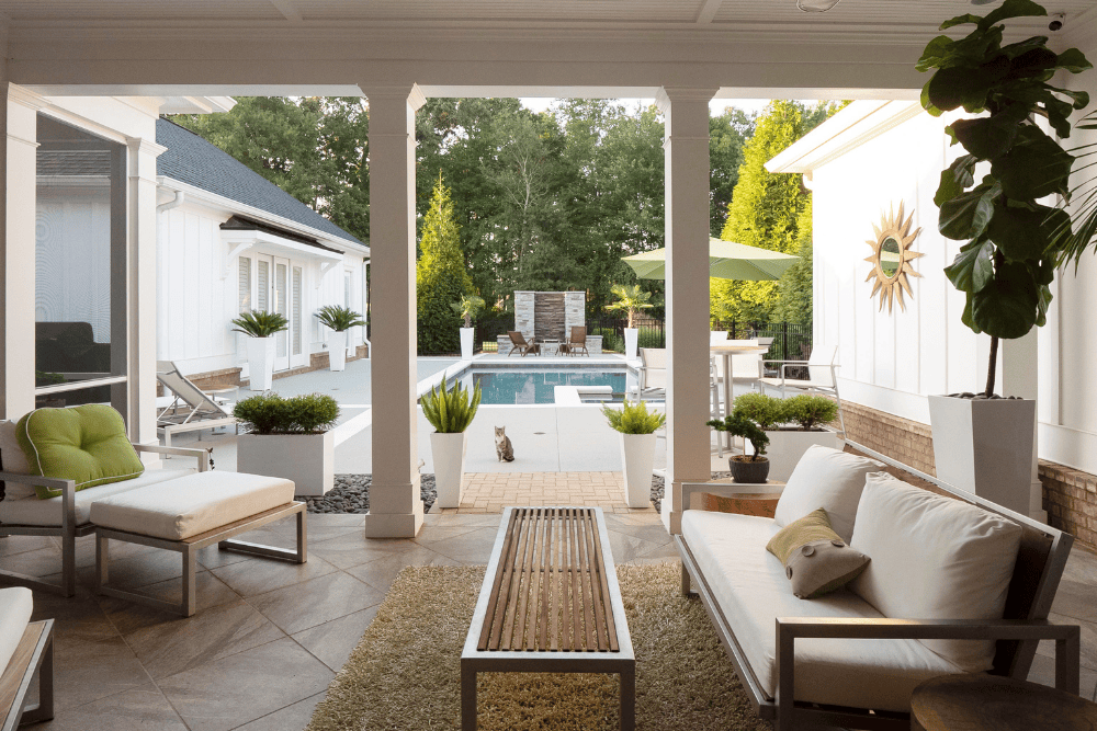 concrete patio with chairs, tables, and a shed