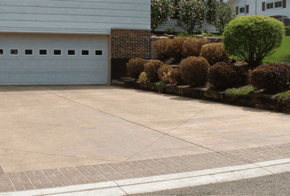 concrete driveway in front of a garage