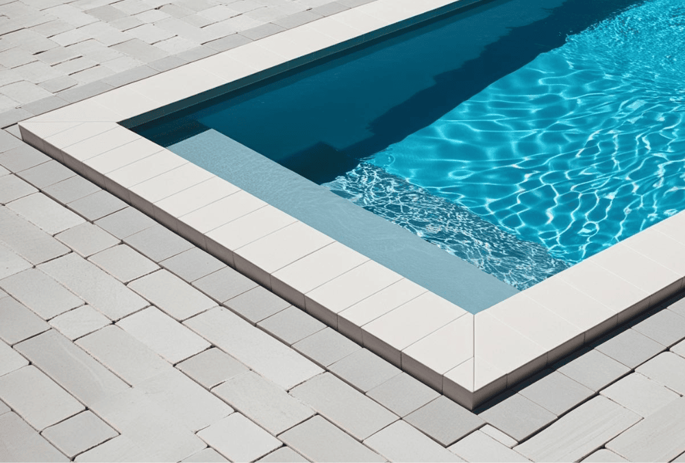 Swimming pool with surrounding deck undergoing professional pool deck leveling for a safe, even surface.