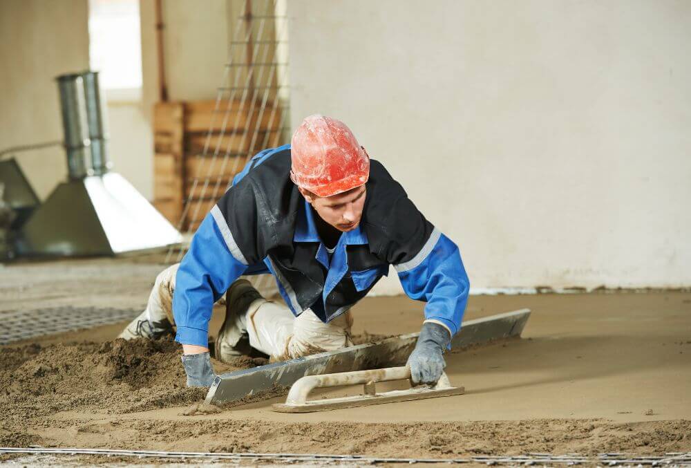 man working on garage flooring