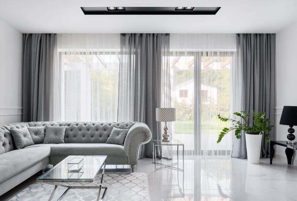 gray themed living room area with gray curtain ang couch
