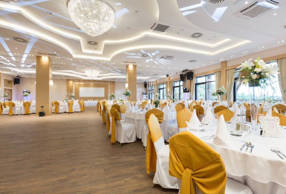 hotel function hall decorated in gold and white motif