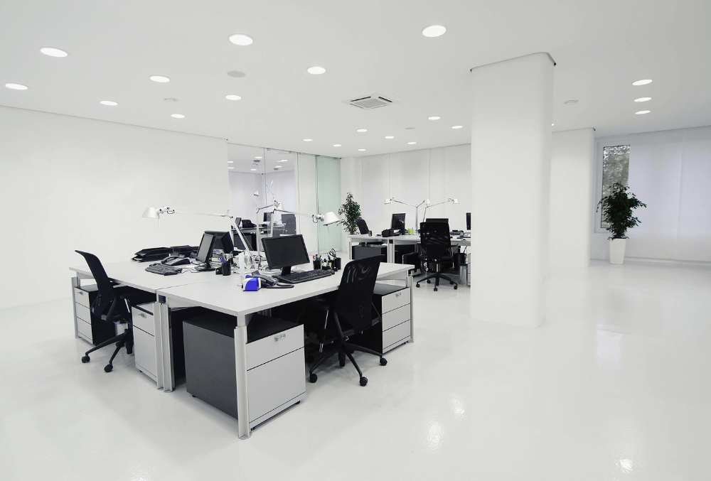 ell-organized office space with a table, chairs, and computers