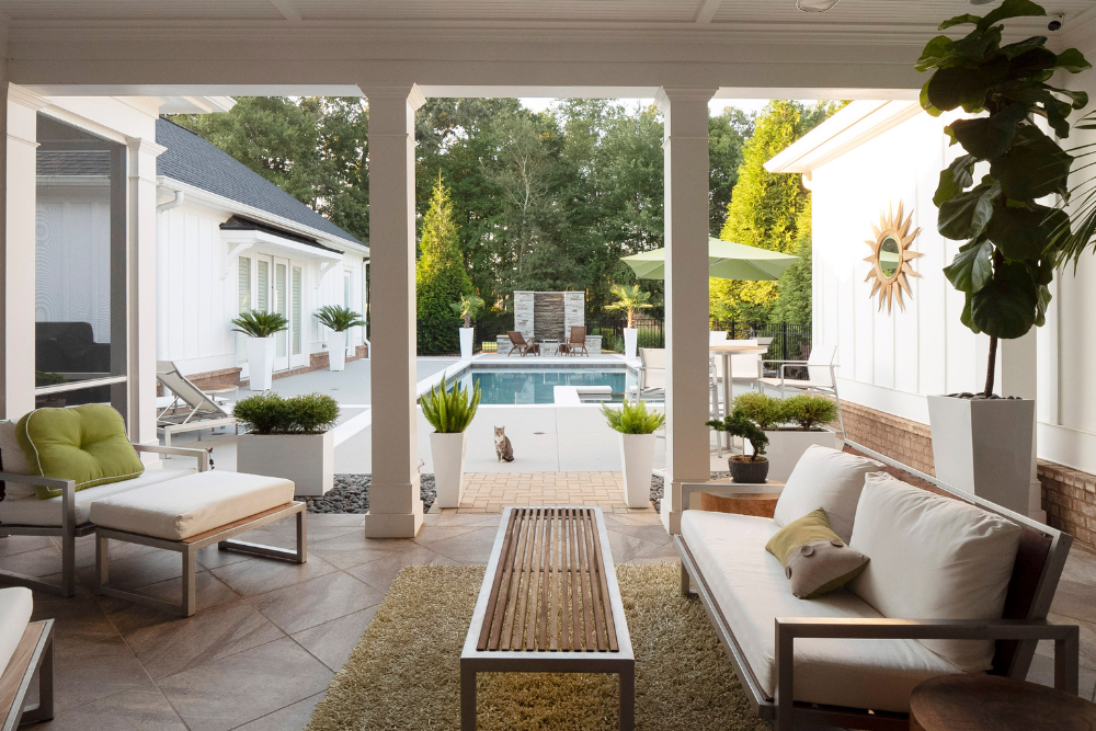 concrete patio with chairs, tables, and a shed
