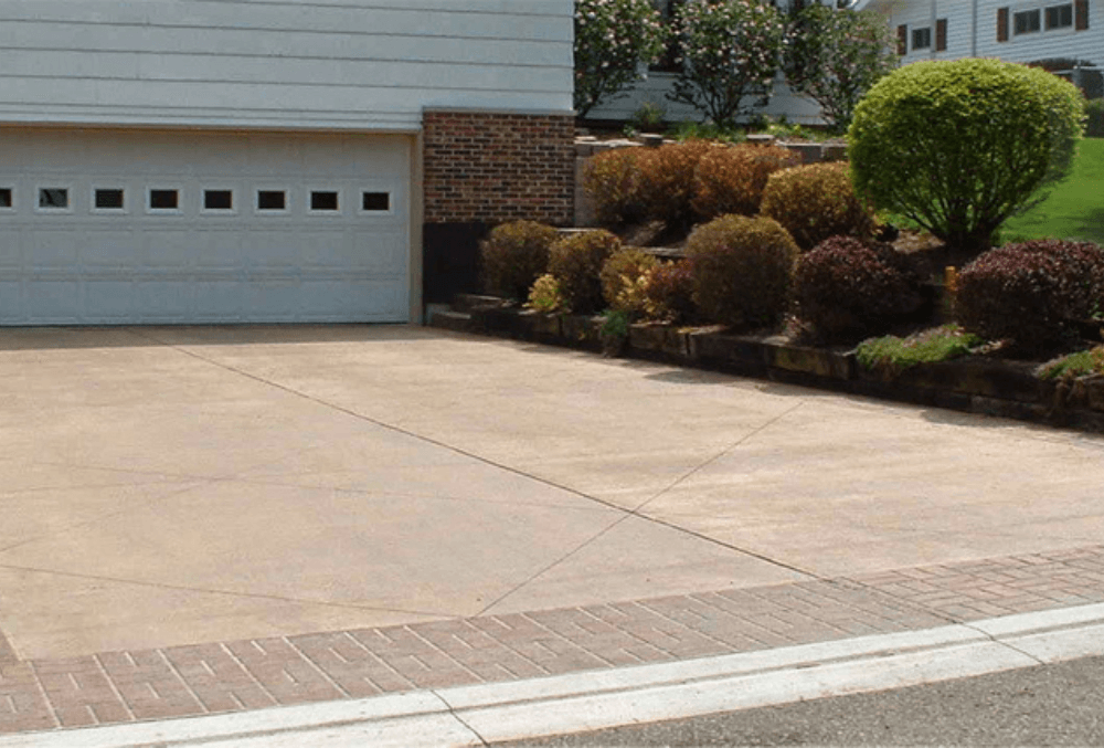 concrete driveway in front of a garage