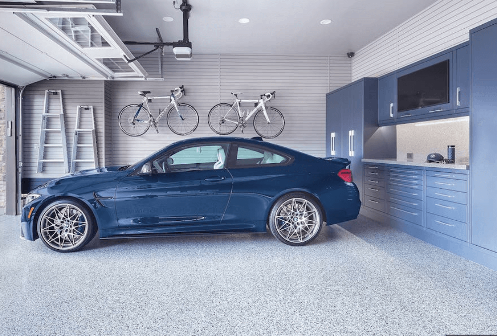 blue car on a concrete garage floor