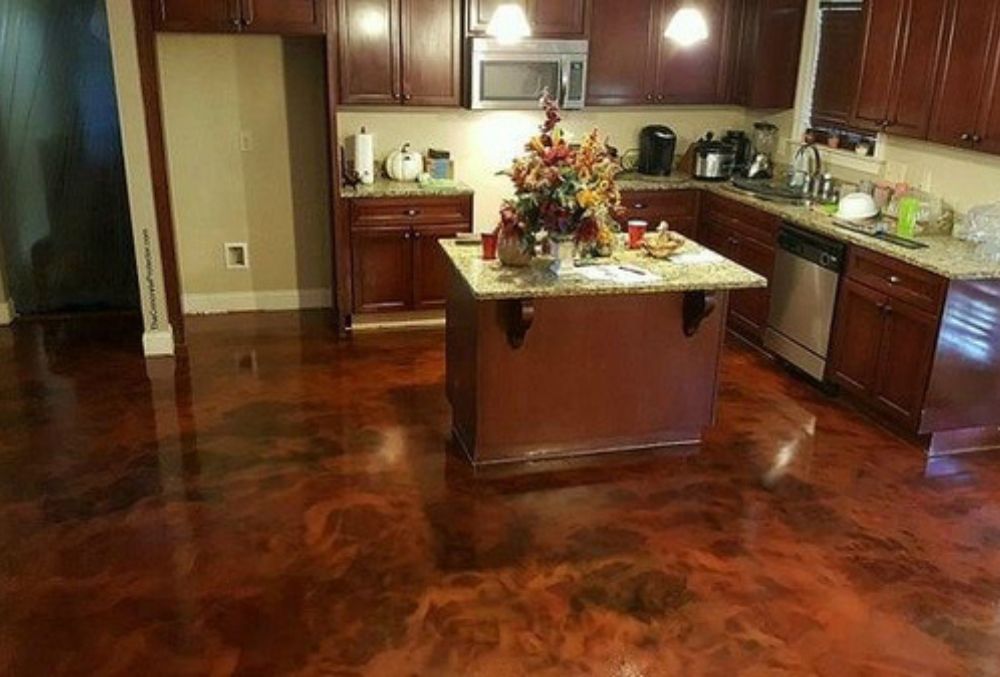stained concrete kitchen floor with an island